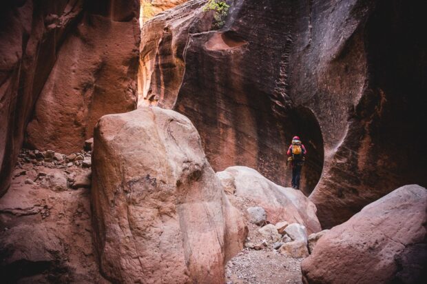 Hiker Canyoning Through Yankee Doodle Slot Canyon