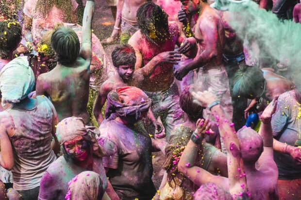 Locals and Tourists Throwing Colored Powders during Holi In Pushkar India