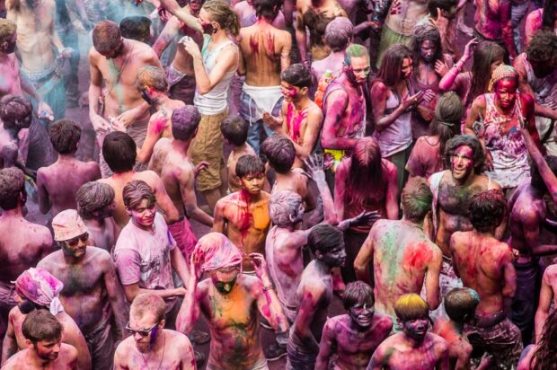 Locals and Tourists Throwing Colored Powders during Holi In Pushkar India