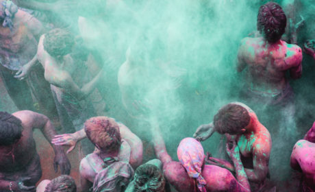 Man Tossing Colored Powder Into The Air During The Holi Festival In Puhskar India