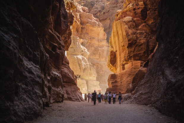Visitors walking through the valley of Petra