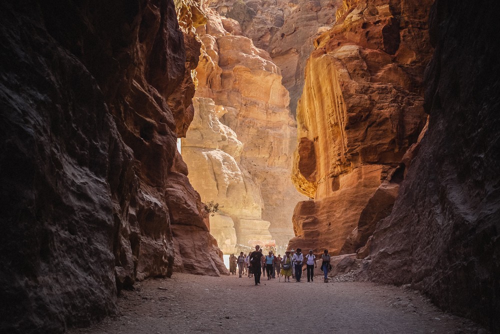 Visitors walking through the valley of Petra