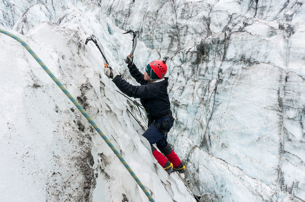Ice climber climbing on Fox Glacier in New Zealand