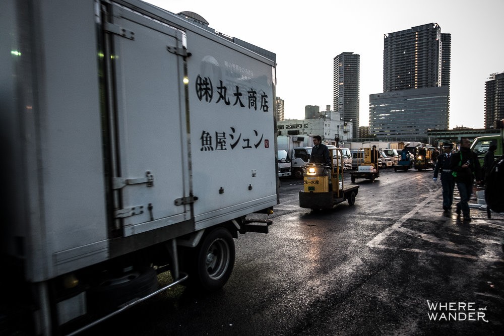 Outside Tsukiji Fish Market At Dawn While Forklifts And Trucks Go By