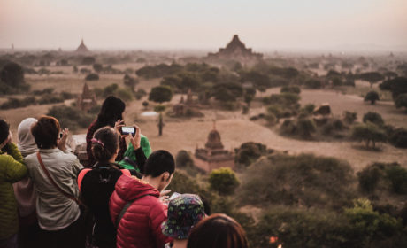 Tourists on top of pagodas at dawn in Bagan