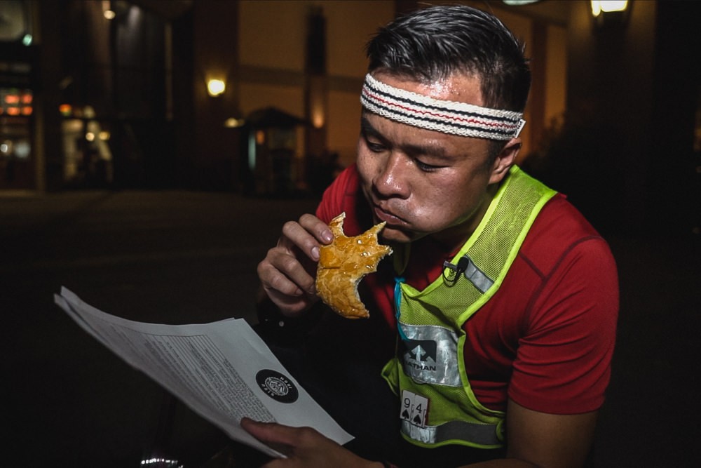 Racer eating pineapple bun wearing fila vintage retro headband