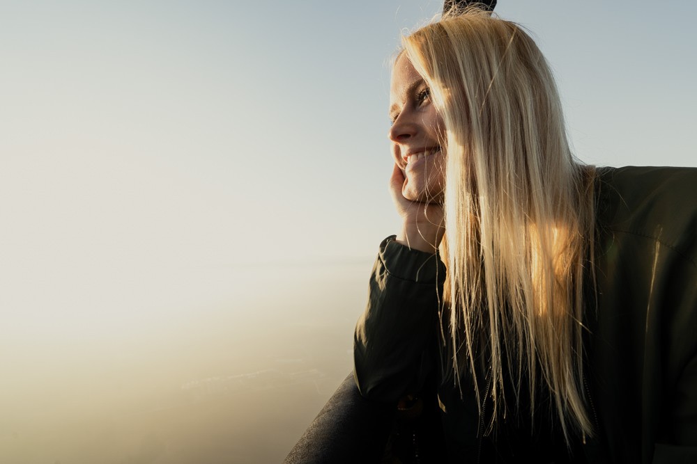 Swedish girl looking out of hot air balloon smiling