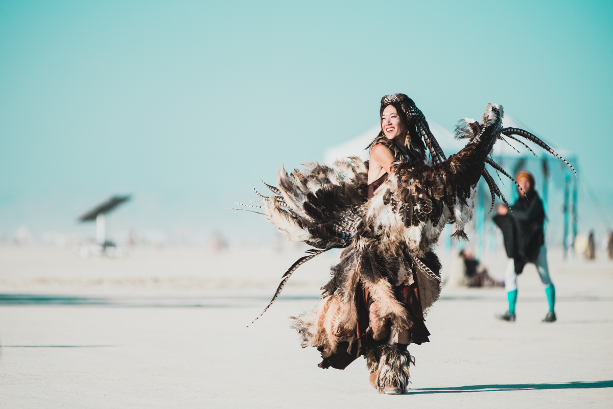 Girl In Feather Burning Man