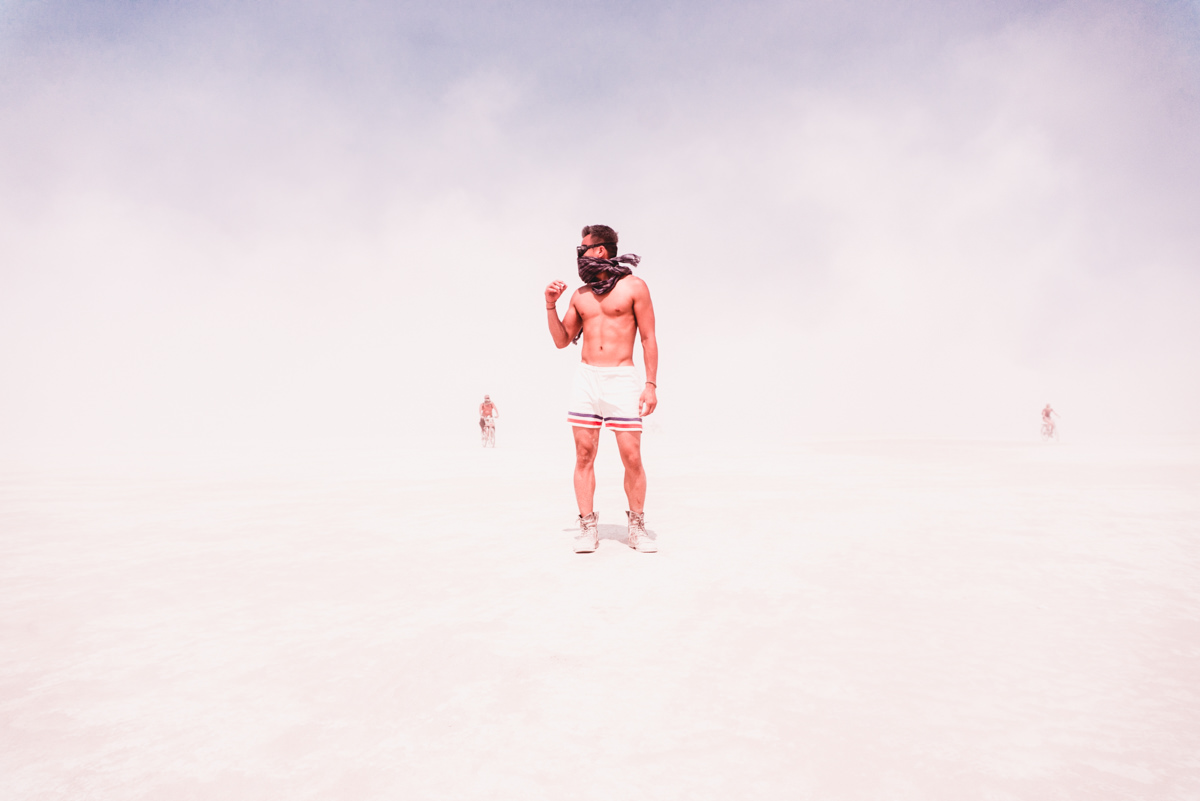 Man Standing At Burning Man In White Out on Playa