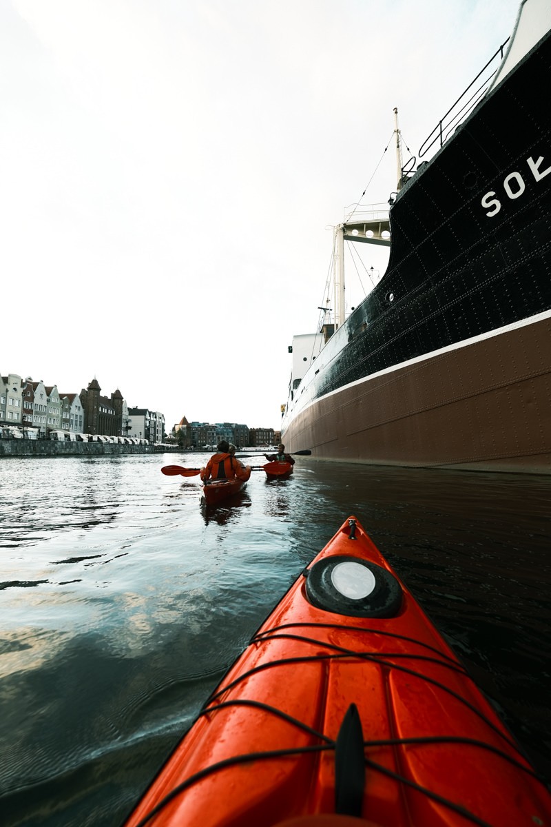 Kayakers approaching Soldek ship
