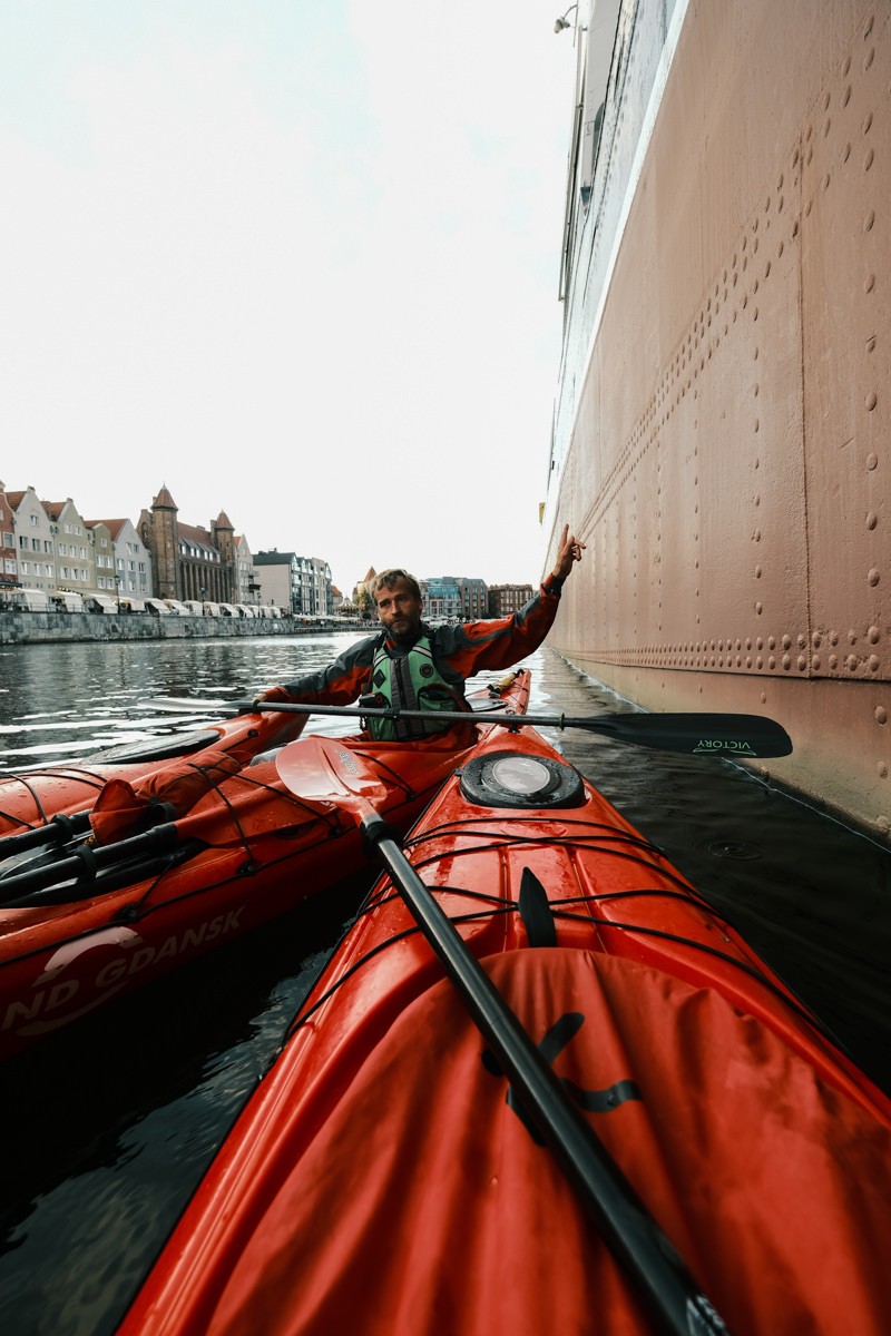 Kayakers next to Soldek ship in Gdansk harbor