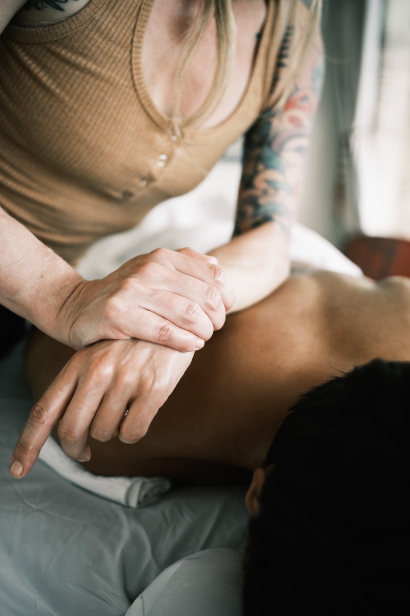 Woman using elbow to massage upper back