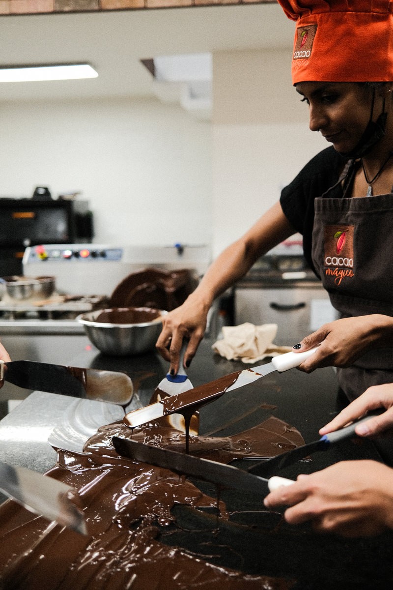 Guests tempering chocolate at Cacao Magico
