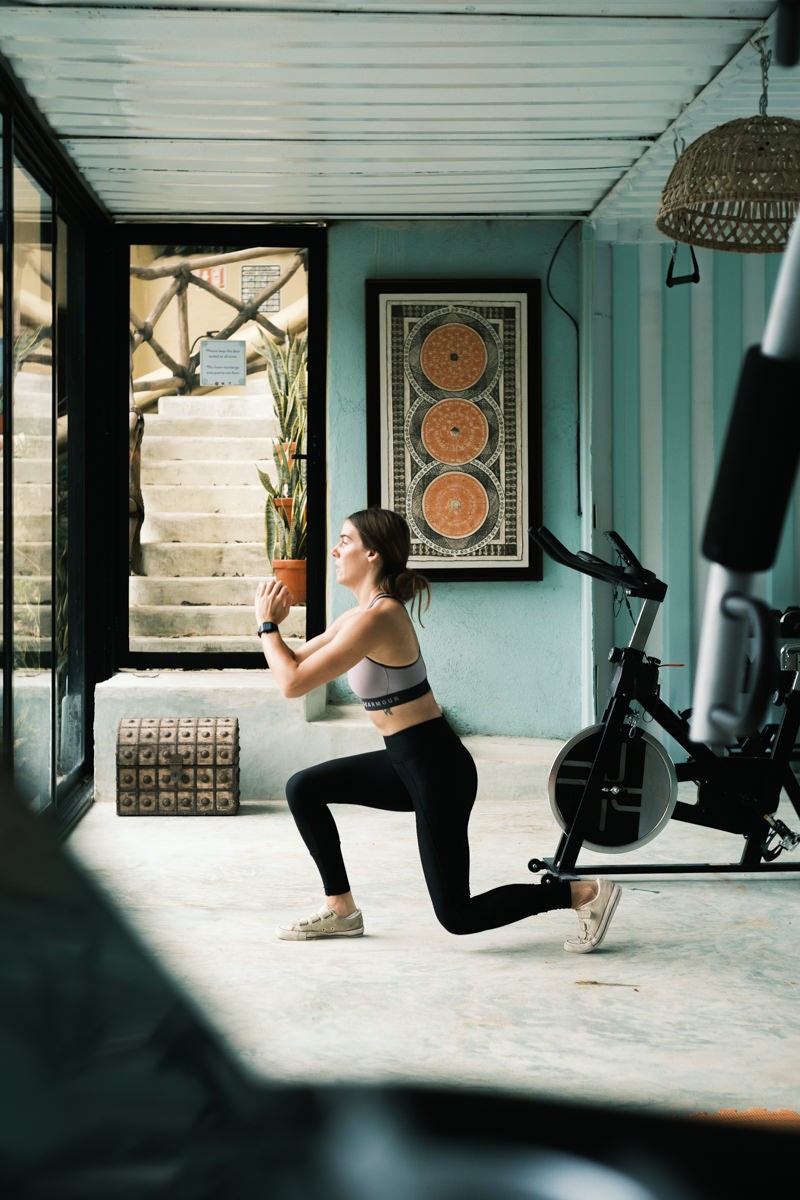 Woman doing lunges in tribal gym at Local Tribe de Mexico