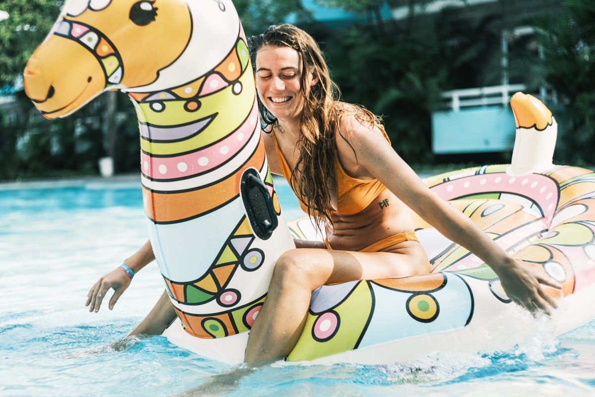 Girl playing on Giant llama pool floaty