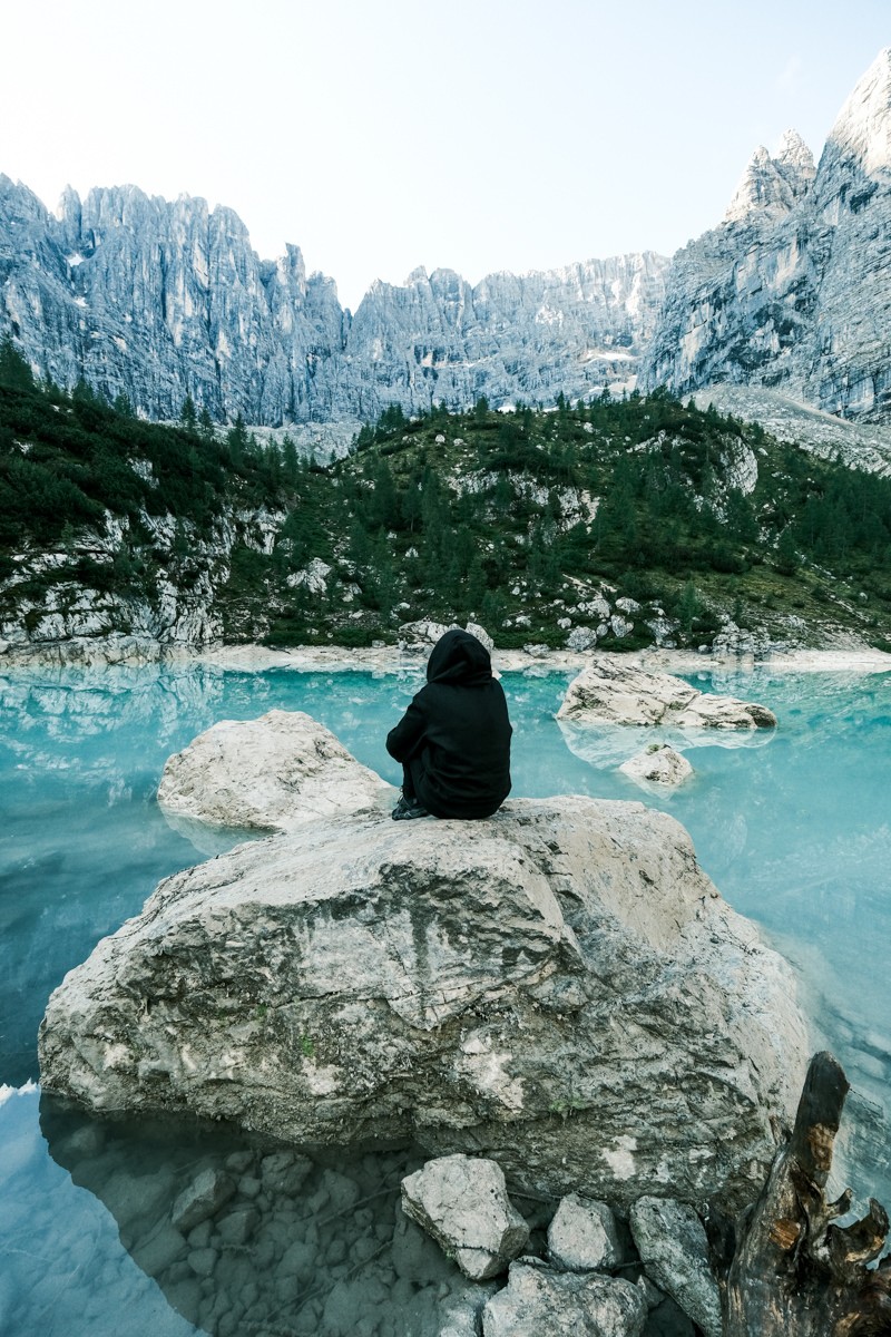 Woman sitting on a rock at Lago di Sorapis