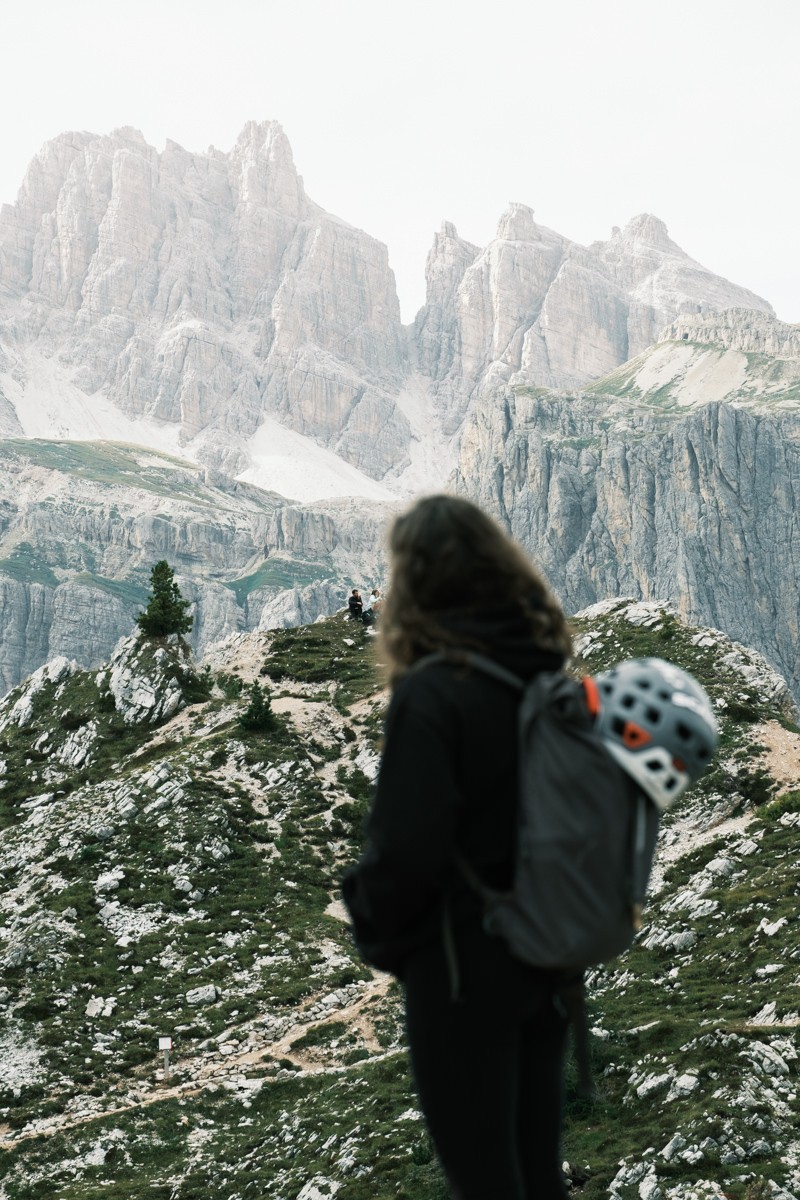 Hiker overlooking mountains in the Dolomites