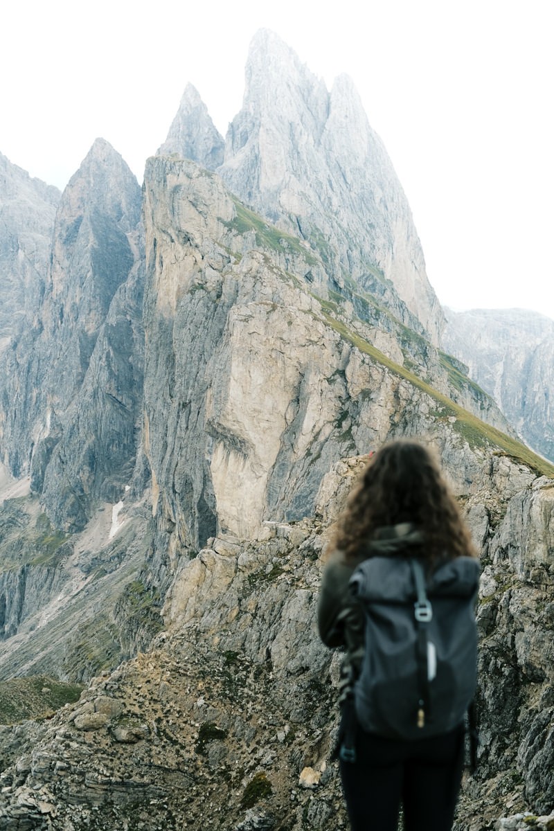 Climber standing on Seceda Ridgeline in the Dolomites shot on Fujifilm X-T4