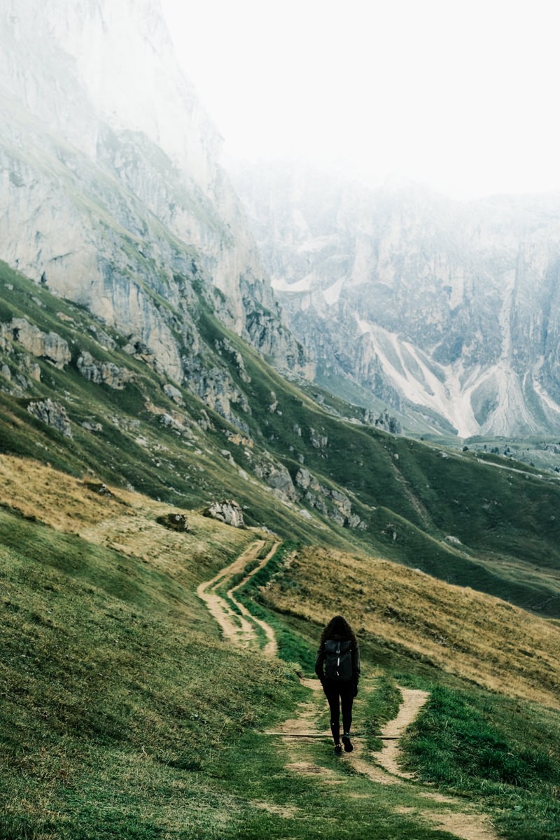 Hiker going down Seceda Ridgeline in the Dolomites shot on Fujifilm X-T4