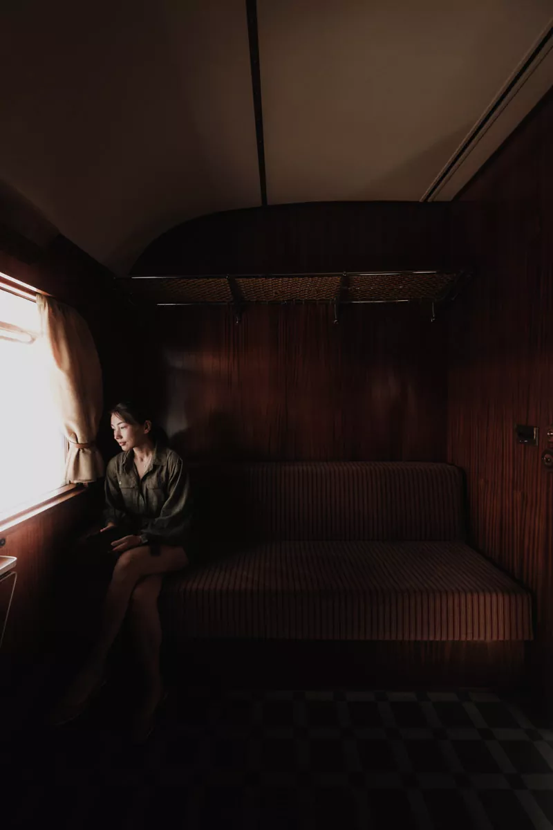 woman in cabin looking out window on the presidential train