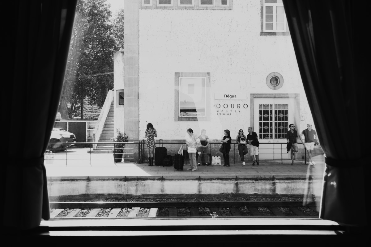 black and white passengers waiting for train at regua station in Portugal
