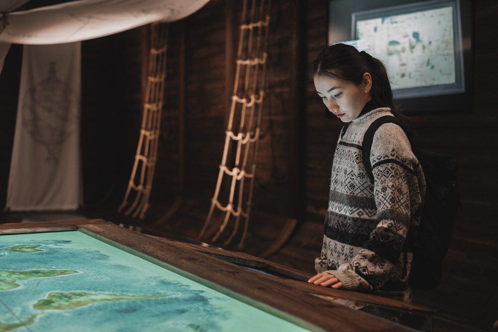 girl standing in replica ship galley at porto region through the ages museum at wow porto