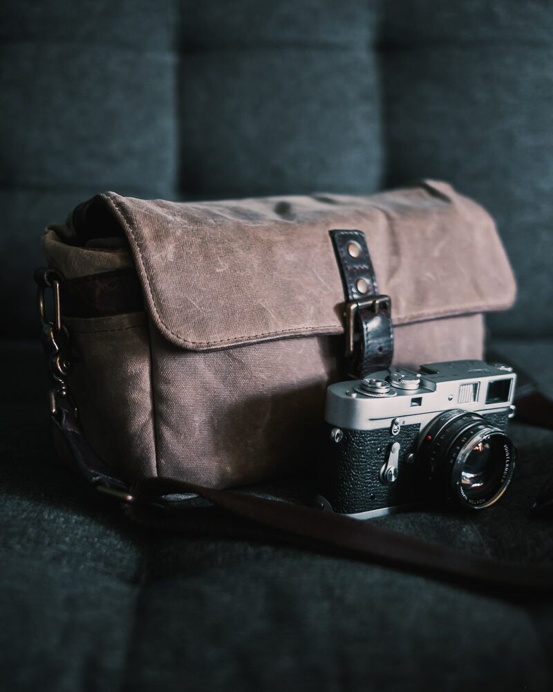 Ona Bowery waxed canvas bag in field tax with Leica M2