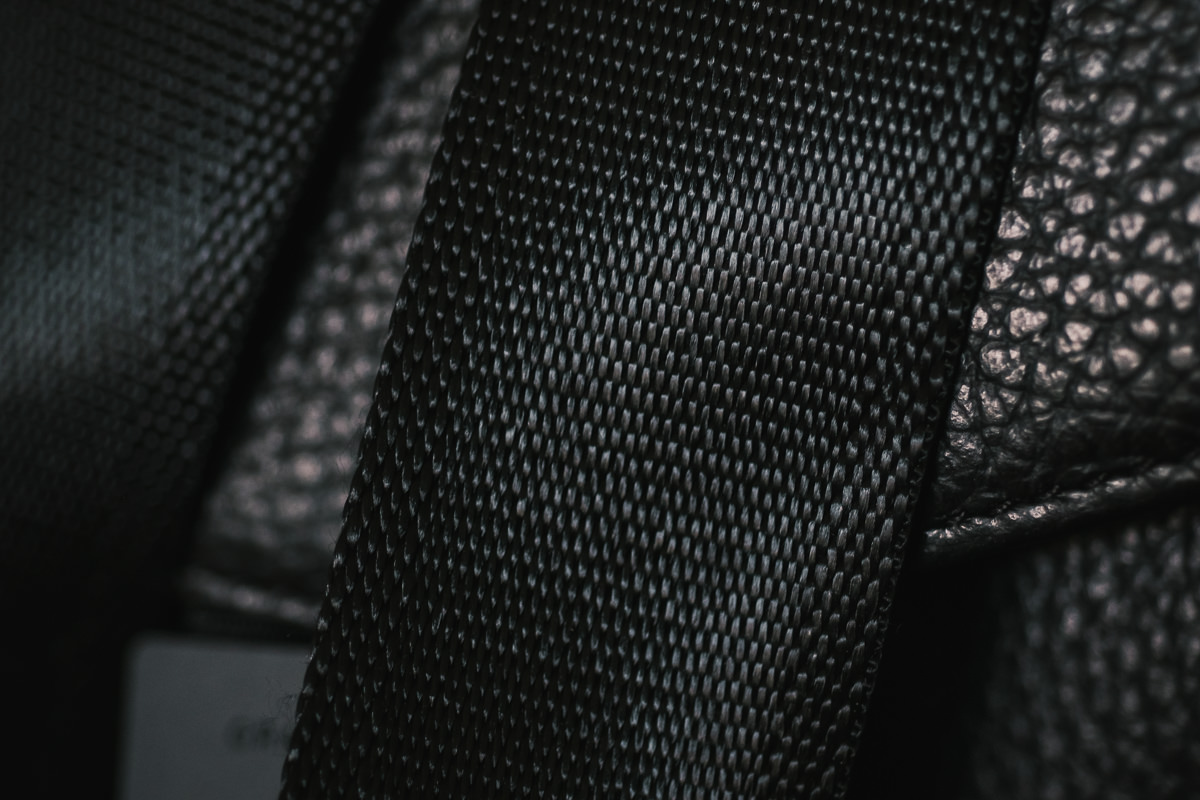 Seatbelt style camera bag strap