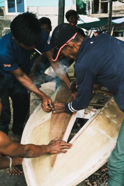Men building a boat on Mabul Ialnd