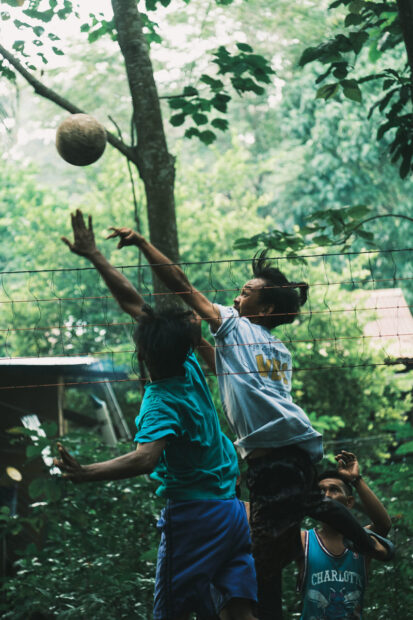 Two boys playing volleyball on Mabul Island