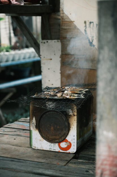 Fish being grilled over makeshift grill on Mabul Island