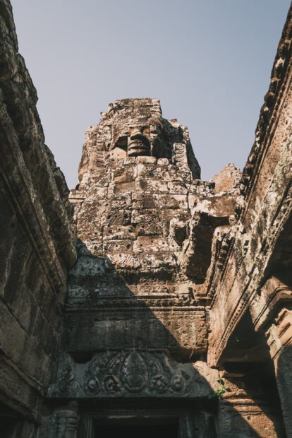 View of towering face at Bayon Temple emerging from tunnel