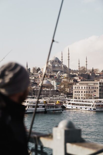fisherman at Galata bridge overlooking Sultanahmet mosque