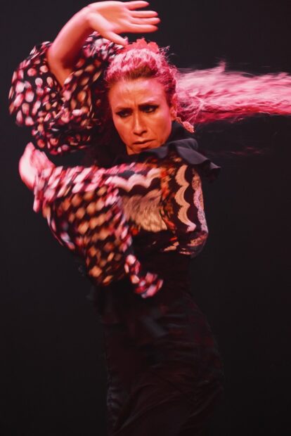 Flamenco dancer twirling at Teatro Flamenco Sevilla