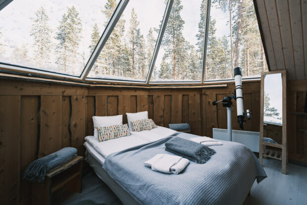 Bed under glass roof in aurora cabin in Saariselka