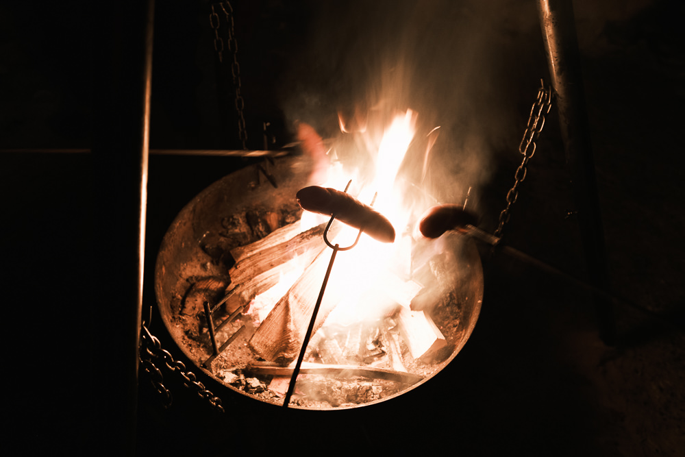 Finnish sausage grilled over fire in teepee Saariselka