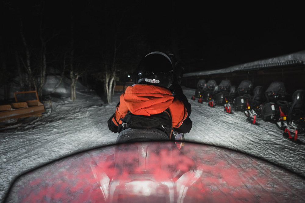 Snowmobile tour at night in Lapland Saariselka