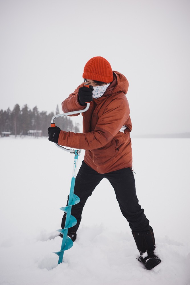 Drilling ice hole at Norvajarvi Lake in Rovanemi