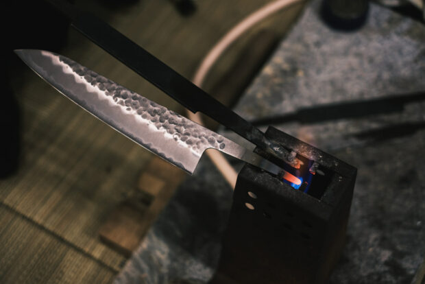 Hammered Gyuto blade in Japan with handle being heated.