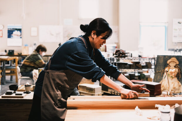 Aki Tanaka using a wood planing tool.