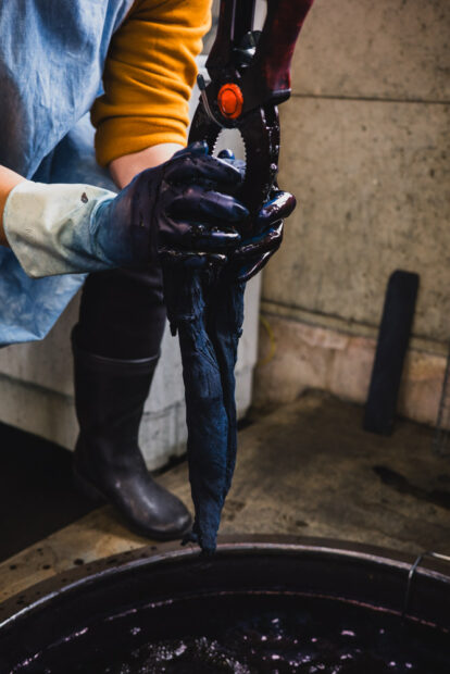 Wringing out excess indigo dye from fabric