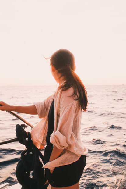 Girl watching sunset from Santorini Caldera