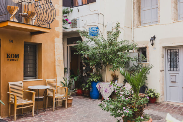 Cute alley street in Chania with flowers and chairs
