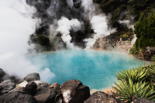 Steam vents rising from milky blue pond at Umi Jigoku Hells of Beppu