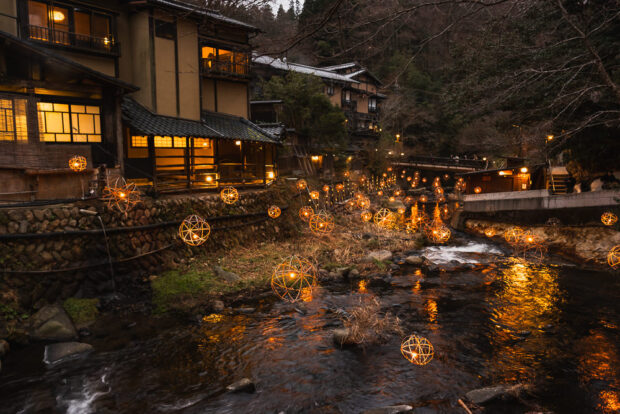Lanterns over Tanoharu River at night at Kurokawa Onsen