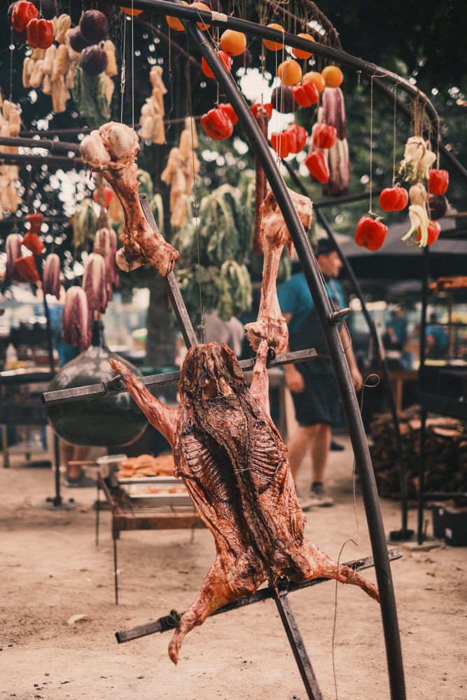 Pig roasting over open flame at Chefs of Fire Aveiro