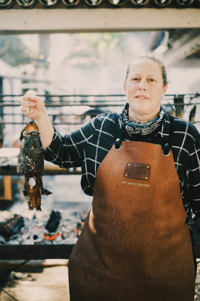 Chef Marta Figuerido posing with fish head at Chefs on Fire Cascais