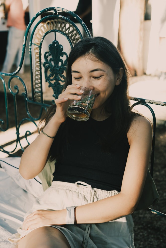 Girl smiling on vintage bed at Chefs on Fire Portugal