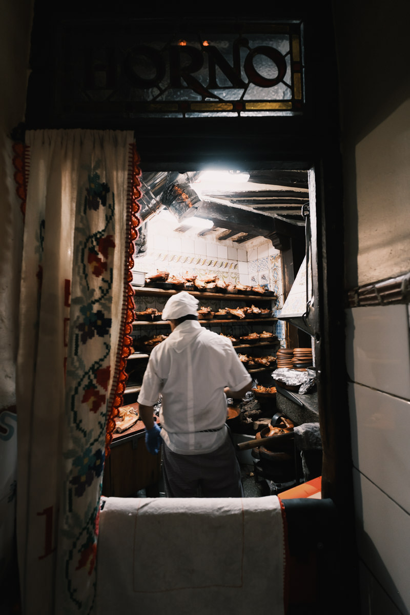 Chef preparing suckling pig in Botin kitchen