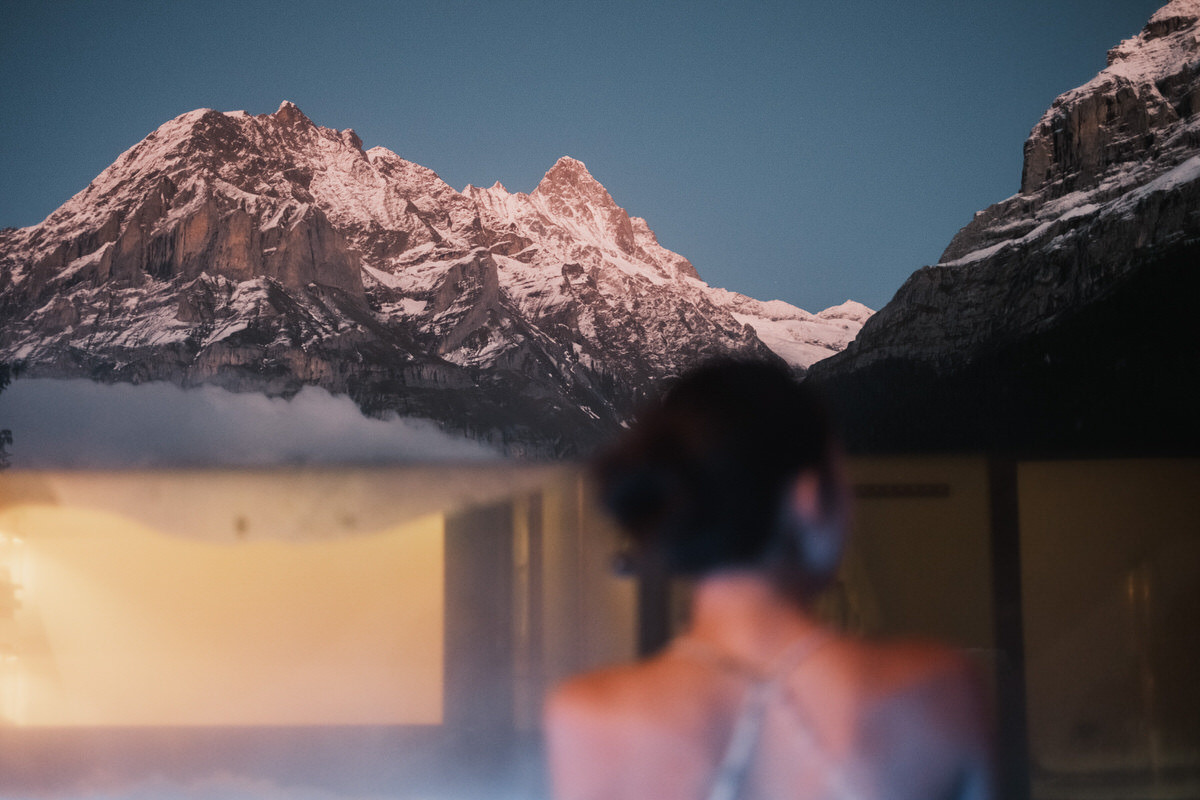 Woman staring at mountain at night at Aspen Alpine Hotel in Grindelwald